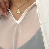 Gold necklace with a sun pendant