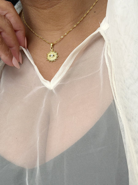 Gold necklace with a sun pendant