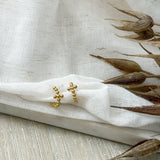 Gold cross-shaped hoop earrings