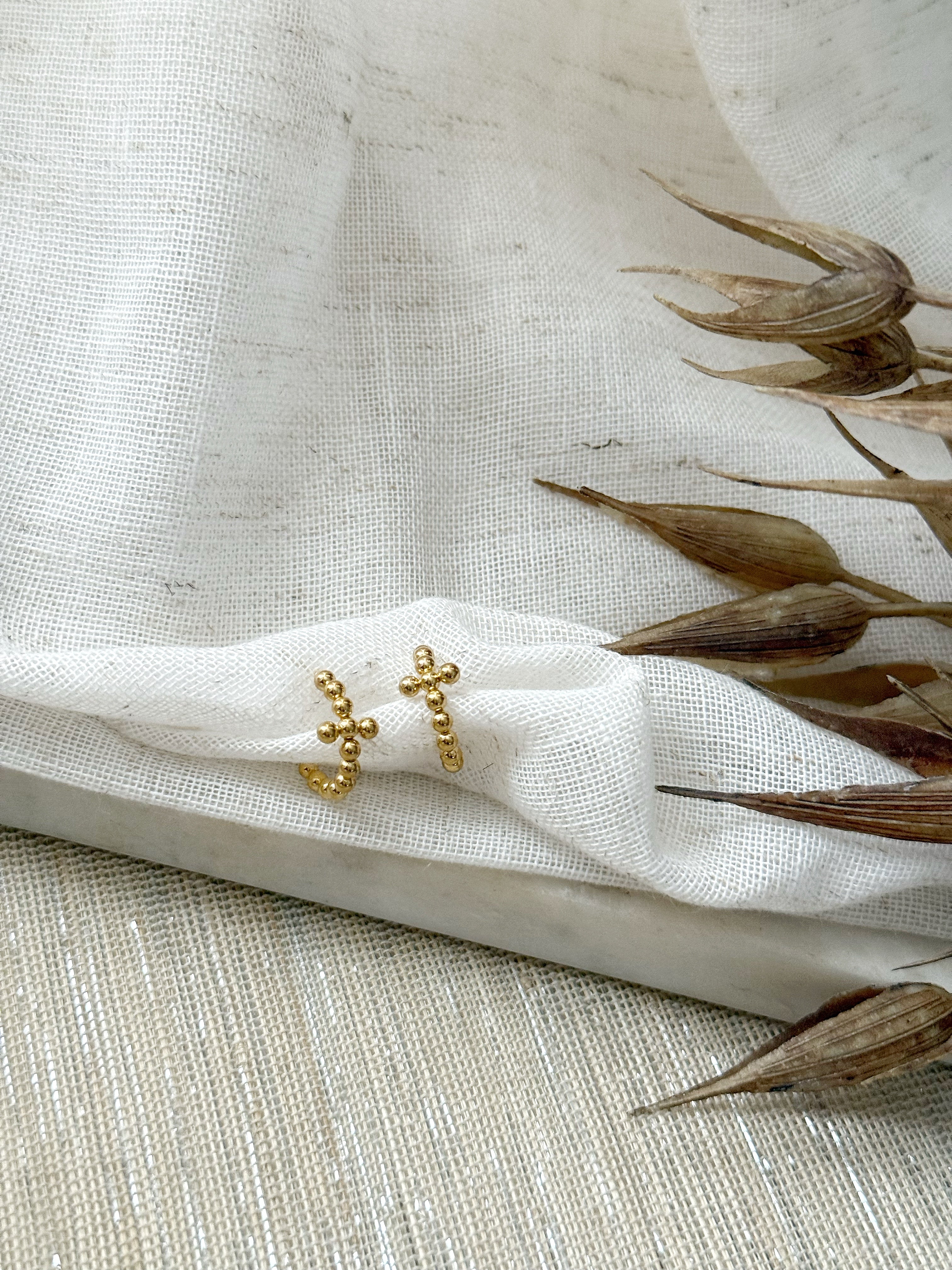 Gold cross-shaped hoop earrings